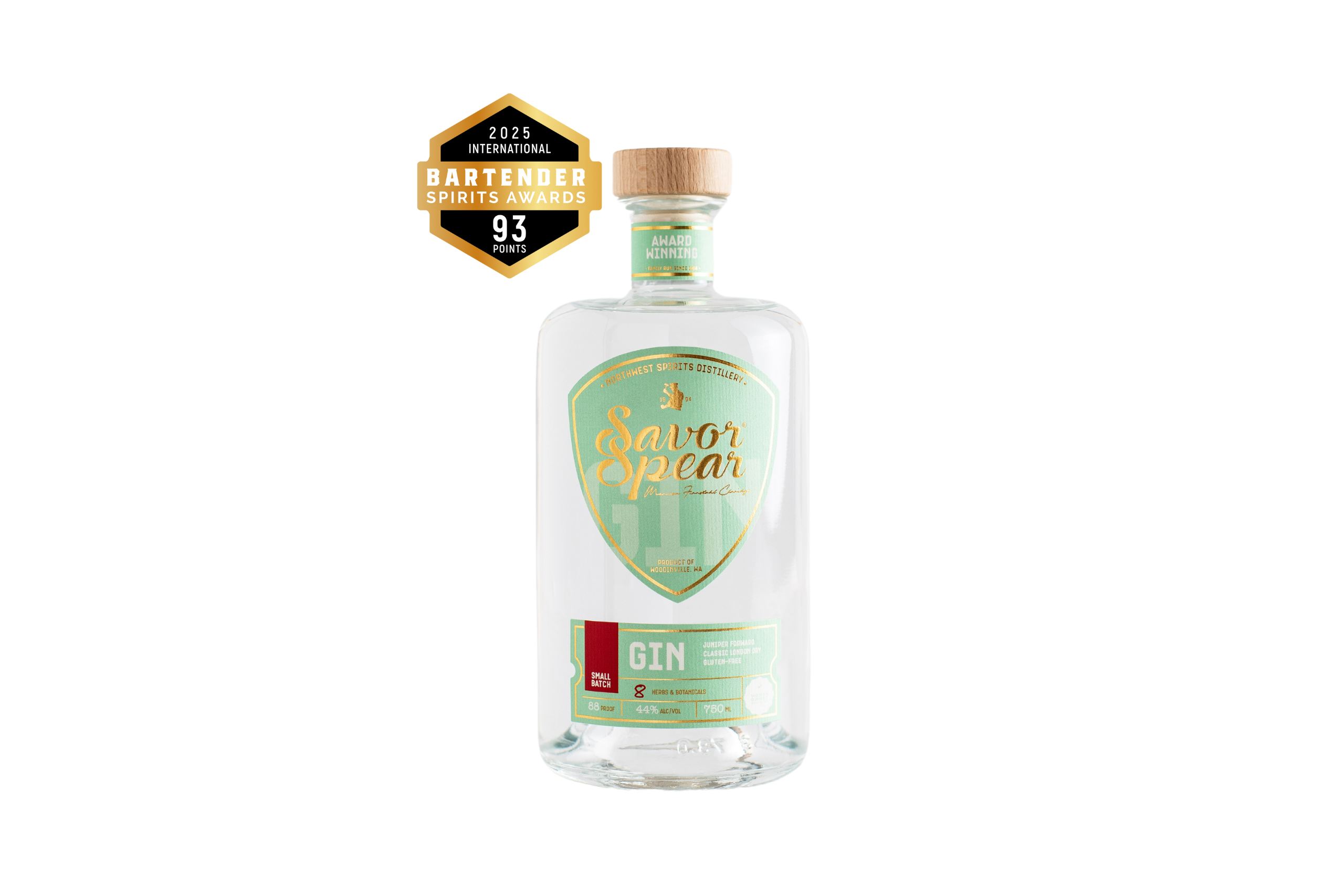 A bottle of Savor Spear Gin by Northwest Spirits is shown with a clear, modern design. The label is mint green with gold and white accents, featuring the brand name prominently in gold script. The bottle is sealed with a natural wood cap. A badge on the upper left highlights a gold medal from the 2025 International Bartender Spirits Awards, indicating the gin received 93 points.