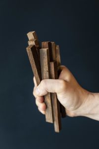 A man is holding a group of wooden oak staves