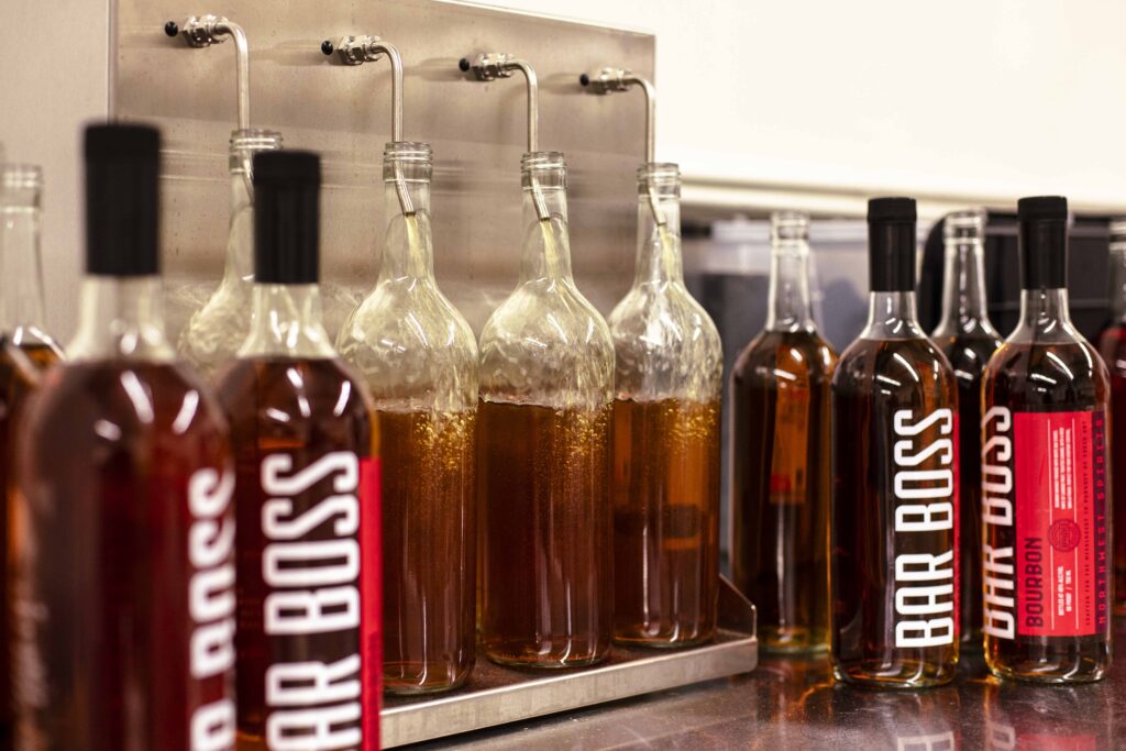 Image of whiskey being bottled in a production facility.